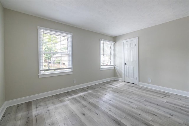 6700 Roswell Rd Unit 21E, Sandy Springs, GA 30328 - empty room with plenty of natural light, light wood finished floors, and a textured ceiling