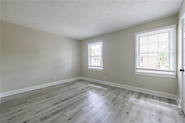 6700 Roswell Rd Unit 21E, Sandy Springs, GA 30328 - unfurnished room with light wood finished floors and a textured ceiling