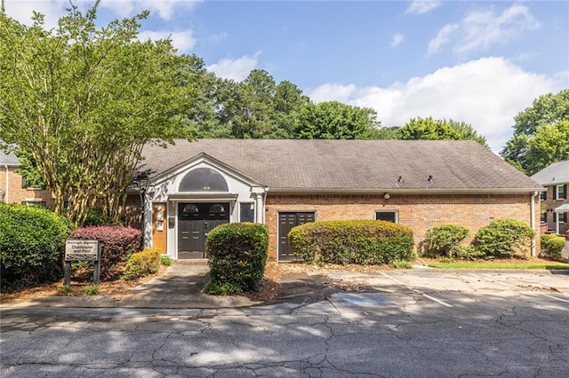 6700 Roswell Rd Unit 21E, Sandy Springs, GA 30328 - view of front of house featuring brick siding and uncovered parking