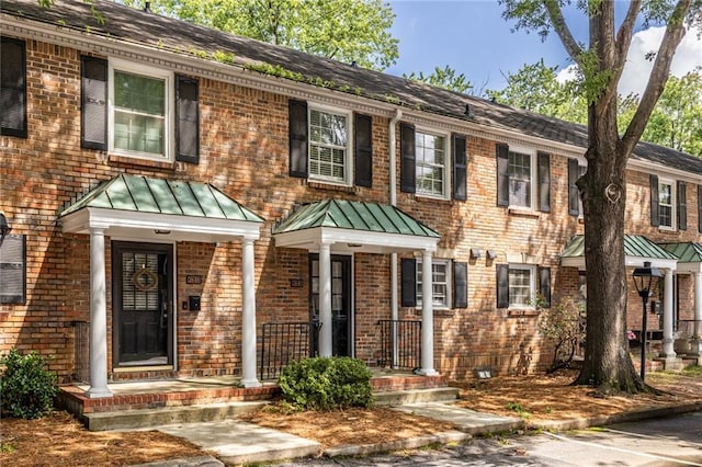 6700 Roswell Rd Unit 21E, Sandy Springs, GA 30328 - view of front of house featuring a standing seam roof, brick siding, and a metal roof