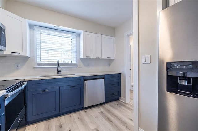 6700 Roswell Rd Unit 21E, Sandy Springs, GA 30328 - kitchen featuring stainless steel appliances, light wood-type flooring, white cabinets, tasteful backsplash, and light countertops