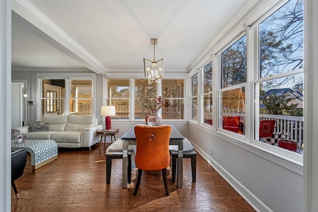 sunroom featuring a notable chandelier and plenty of natural light