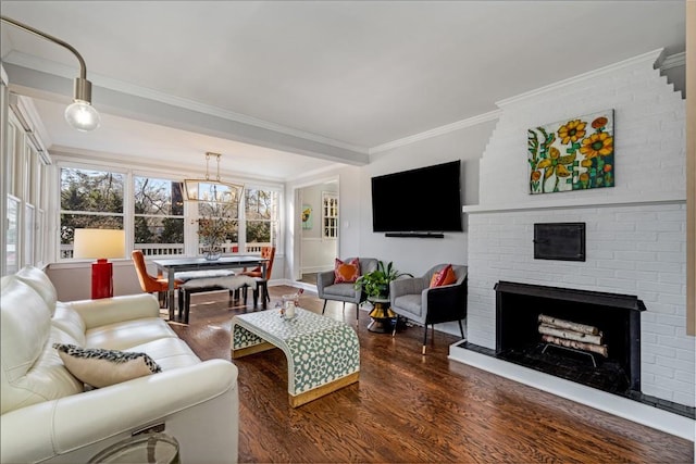 living room featuring ornamental molding, a fireplace, and wood finished floors