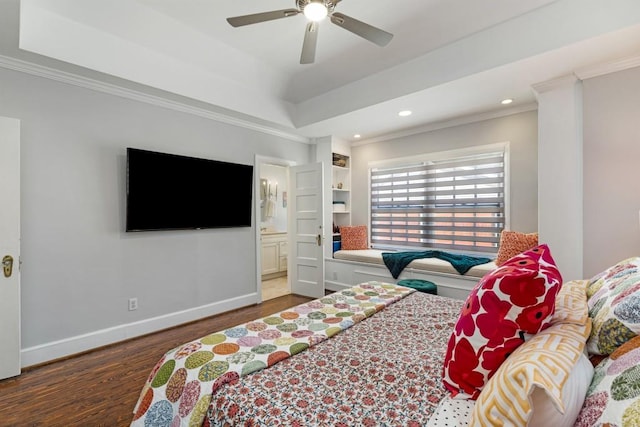 bedroom with baseboards, wood finished floors, a tray ceiling, crown molding, and recessed lighting