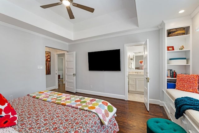 bedroom featuring baseboards, ceiling fan, ornamental molding, wood finished floors, and a tray ceiling