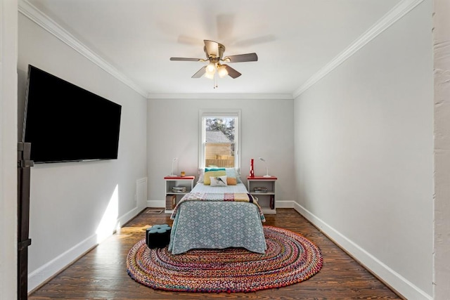 bedroom with crown molding, baseboards, and wood finished floors