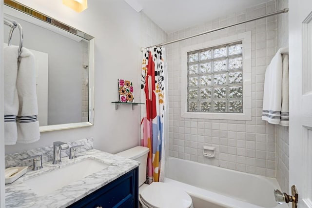 bathroom featuring toilet, shower / bath combo, and vanity