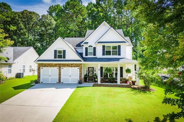 view of front of home featuring a porch, cooling unit, driveway, stone siding, and a front lawn