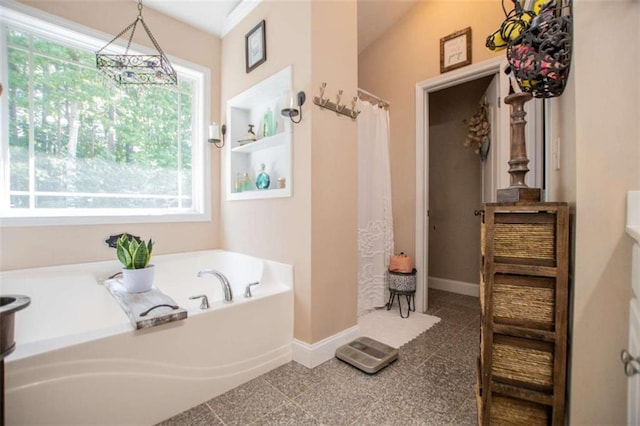 full bath featuring a shower with curtain, a garden tub, and baseboards