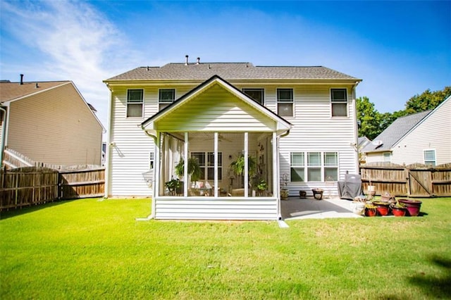 rear view of house featuring a sunroom, a fenced backyard, a patio area, and a yard