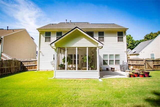 613 Hemlock Ct, Villa Rica, GA 30180 - back of house with a fenced backyard, a lawn, a sunroom, and a patio