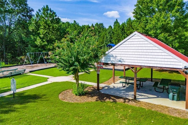 surrounding community with playground community, a lawn, and a gazebo