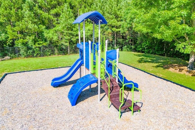 communal playground with a lawn and fence