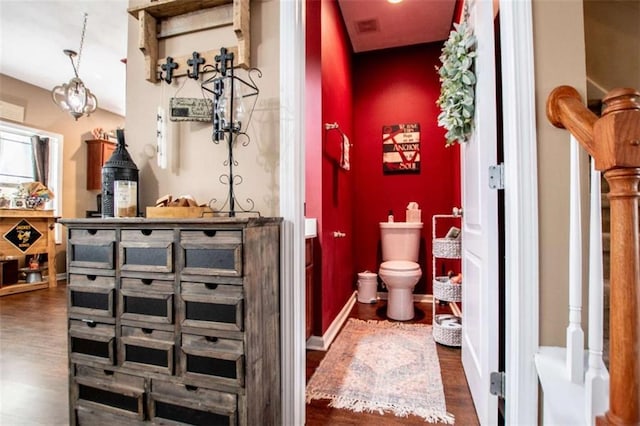 bathroom featuring wood finished floors, toilet, and baseboards