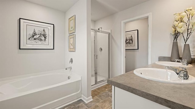 bathroom with vanity and independent shower and bath