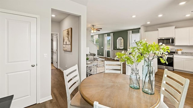 dining area featuring ceiling fan and dark hardwood / wood-style floors