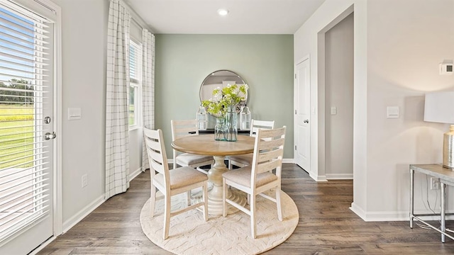 dining area featuring a healthy amount of sunlight and dark hardwood / wood-style flooring