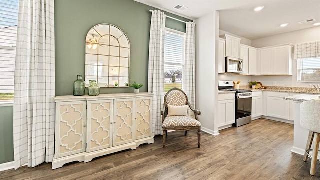 kitchen featuring white cabinetry, hardwood / wood-style floors, and stainless steel appliances