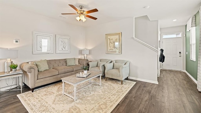 living room with ceiling fan and dark hardwood / wood-style flooring