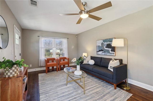 living room featuring ceiling fan and hardwood / wood-style flooring