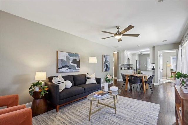 living room with ceiling fan and wood-type flooring