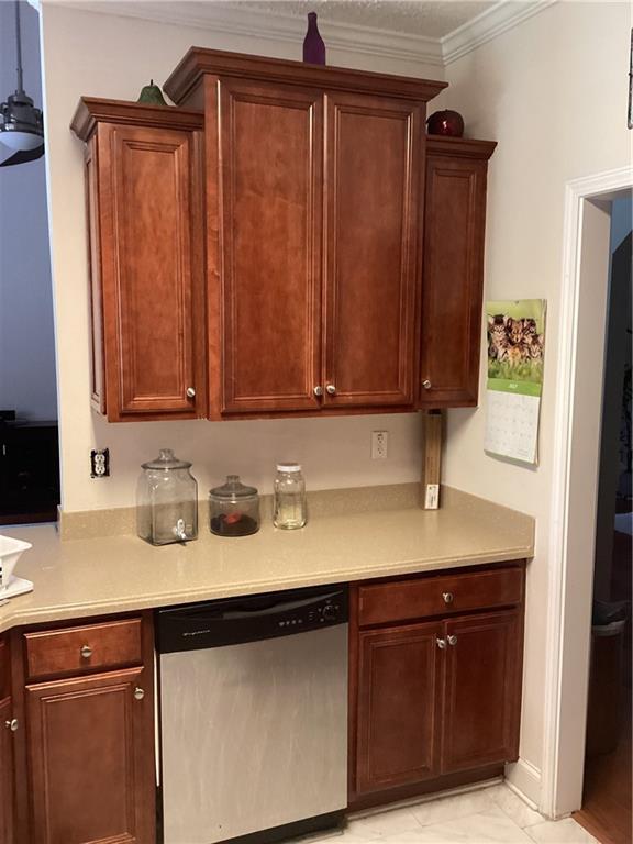 kitchen with crown molding and stainless steel dishwasher