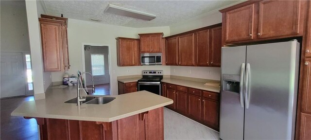 kitchen with sink, a breakfast bar area, stainless steel appliances, a textured ceiling, and kitchen peninsula