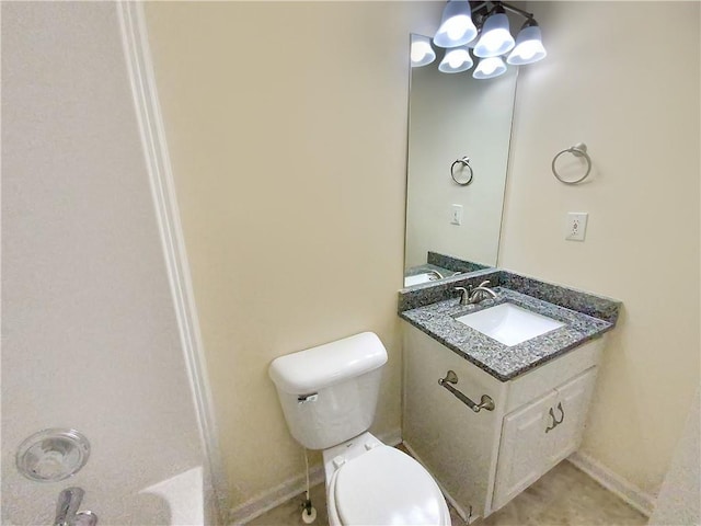 bathroom with vanity, toilet, and baseboards