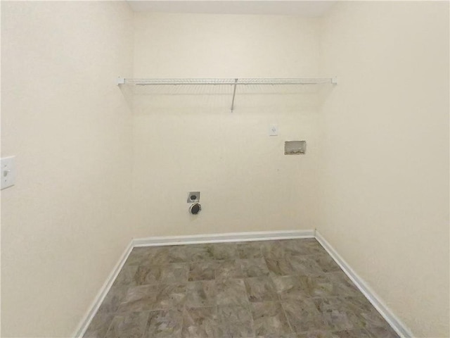 clothes washing area with laundry area, washer hookup, electric dryer hookup, and baseboards