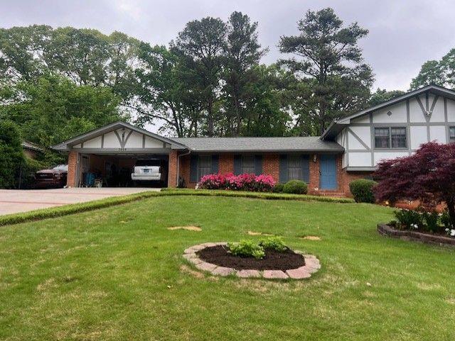 3996 Indian Manor Dr, Stone Mountain, GA 30083 - view of front of property with a front lawn, concrete driveway, brick siding, and an attached garage