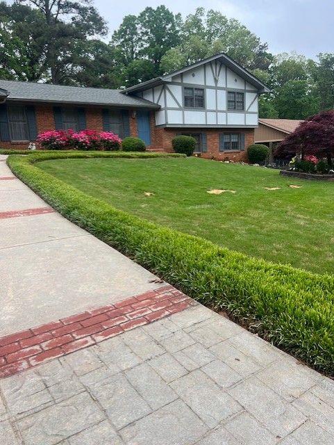 3996 Indian Manor Dr, Stone Mountain, GA 30083 - view of front of house featuring a front yard and brick siding