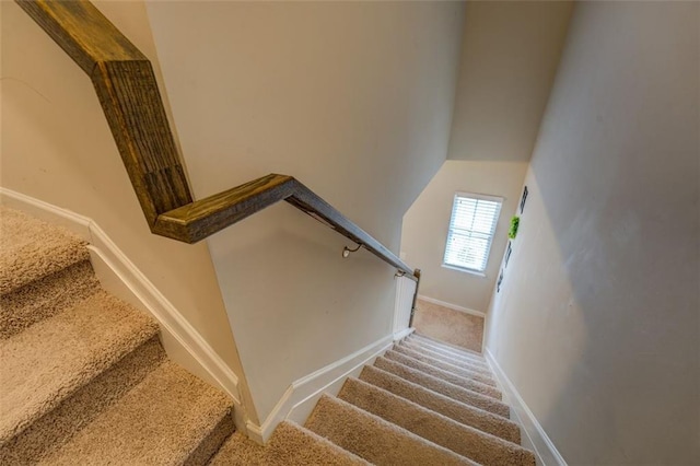 stairway with carpet floors and baseboards