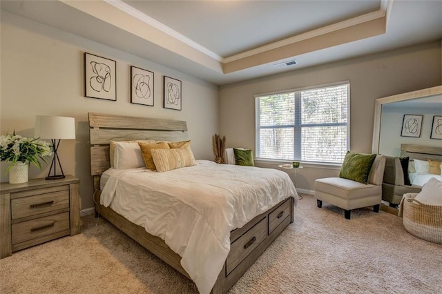 bedroom featuring baseboards, visible vents, light colored carpet, a tray ceiling, and crown molding