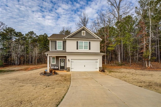 view of front of property featuring an attached garage, stone siding, and concrete driveway