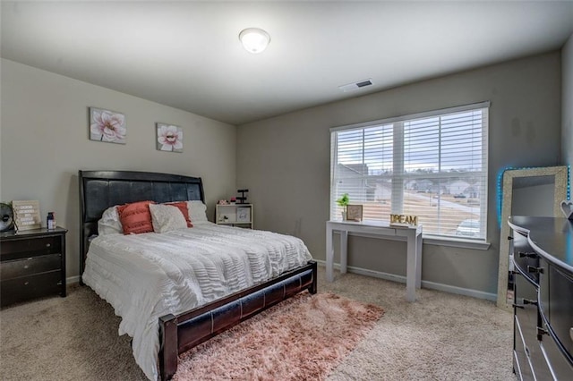 carpeted bedroom with visible vents and baseboards