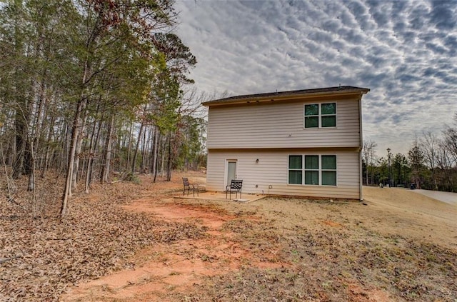 back of property with a patio