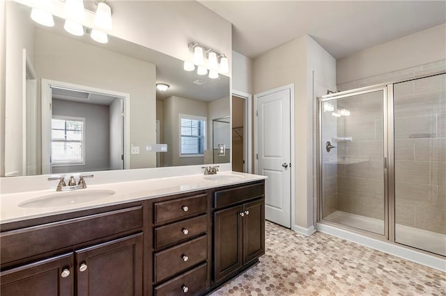 bathroom with walk in shower and vanity