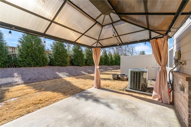 view of patio featuring central AC unit and a gazebo