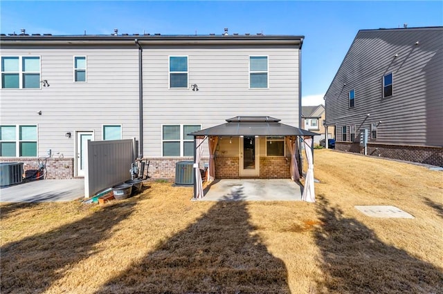 back of house with a gazebo, a yard, cooling unit, and a patio area