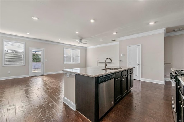 kitchen with an island with sink, appliances with stainless steel finishes, sink, and ornamental molding