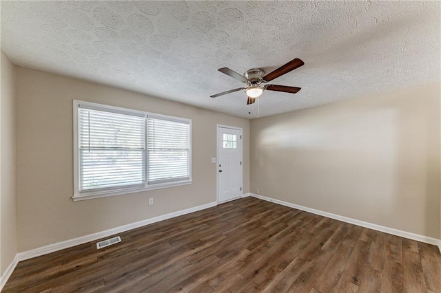 interior space with dark hardwood / wood-style flooring, ceiling fan, and a healthy amount of sunlight