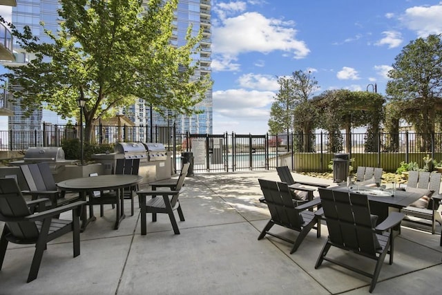 400 W Peachtree St NW Unit 3611, Atlanta, GA 30308 - view of patio featuring area for grilling, outdoor dining area, fence, and a community pool