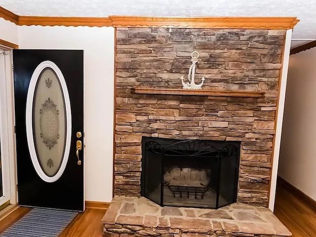 307 Little Hickory Ln, Woodstock, GA 30189 - detailed view of wood finished floors, a stone fireplace, and ornamental molding