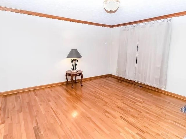 307 Little Hickory Ln, Woodstock, GA 30189 - unfurnished room featuring light wood-style floors and ornamental molding