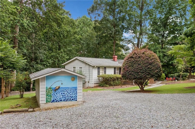 307 Little Hickory Ln, Woodstock, GA 30189 - view of front of home featuring a shed, a chimney, and a front lawn