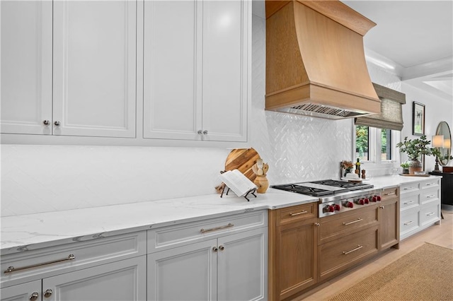 10155 Cedar Ridge Dr, Milton, GA 30004 - kitchen featuring custom exhaust hood, stainless steel gas cooktop, decorative backsplash, light stone counters, and light wood-type flooring