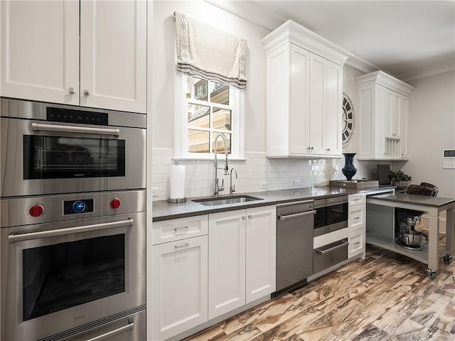 10155 Cedar Ridge Dr, Milton, GA 30004 - kitchen featuring a sink, stainless steel appliances, ornamental molding, white cabinetry, and tasteful backsplash