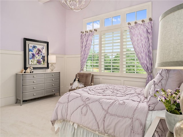 10155 Cedar Ridge Dr, Milton, GA 30004 - carpeted bedroom with a decorative wall, a wainscoted wall, and a chandelier