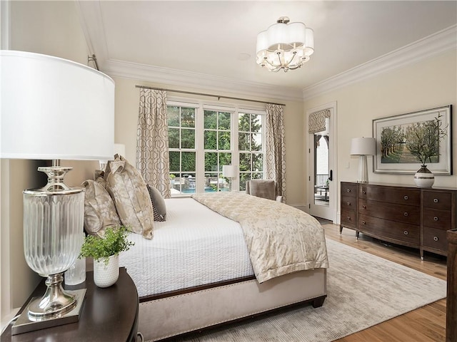 10155 Cedar Ridge Dr, Milton, GA 30004 - bedroom featuring crown molding, wood finished floors, and a chandelier