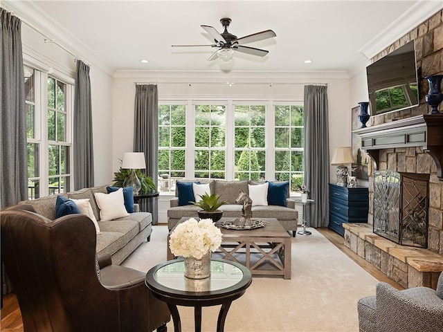 10155 Cedar Ridge Dr, Milton, GA 30004 - living room featuring a ceiling fan, light wood-type flooring, a stone fireplace, ornamental molding, and recessed lighting